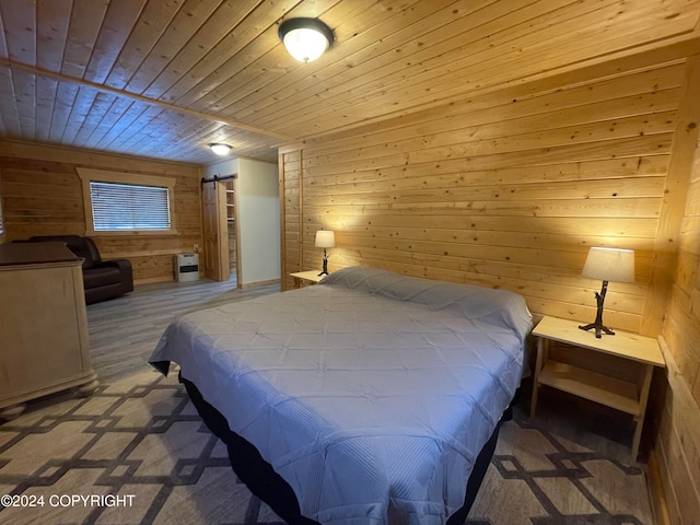 bedroom with a barn door, wood walls, heating unit, and wood ceiling