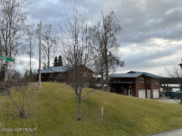 view of front of home featuring a garage and a front lawn