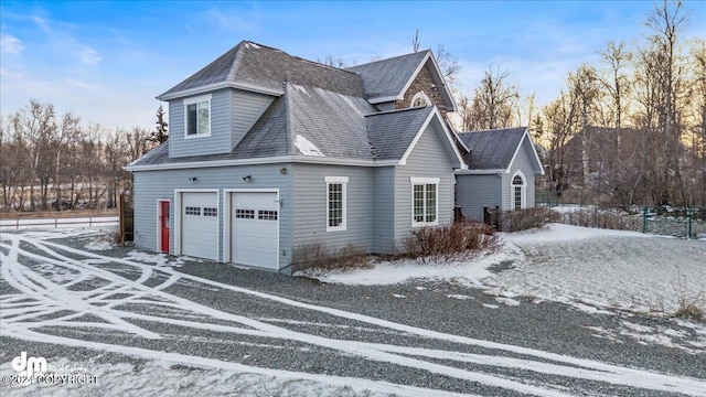 view of snow covered exterior featuring a garage