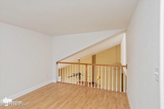 interior space featuring hardwood / wood-style floors and lofted ceiling