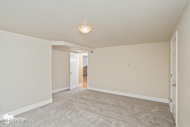 carpeted spare room with a textured ceiling