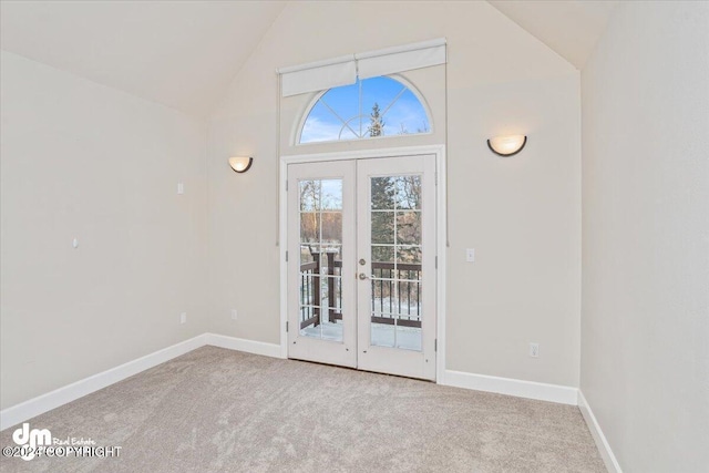 doorway to outside with carpet flooring, french doors, and high vaulted ceiling