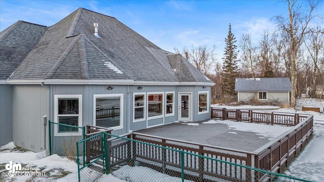 snow covered property featuring a deck