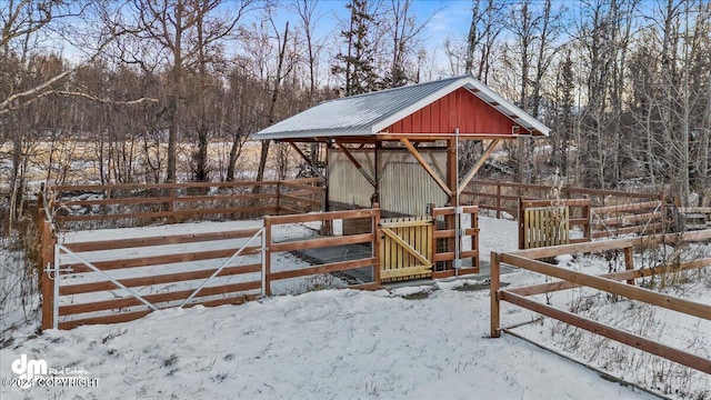 snow covered deck featuring an outbuilding