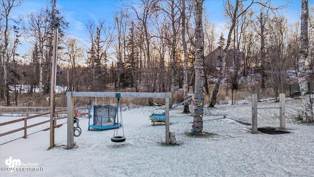 yard covered in snow with a trampoline