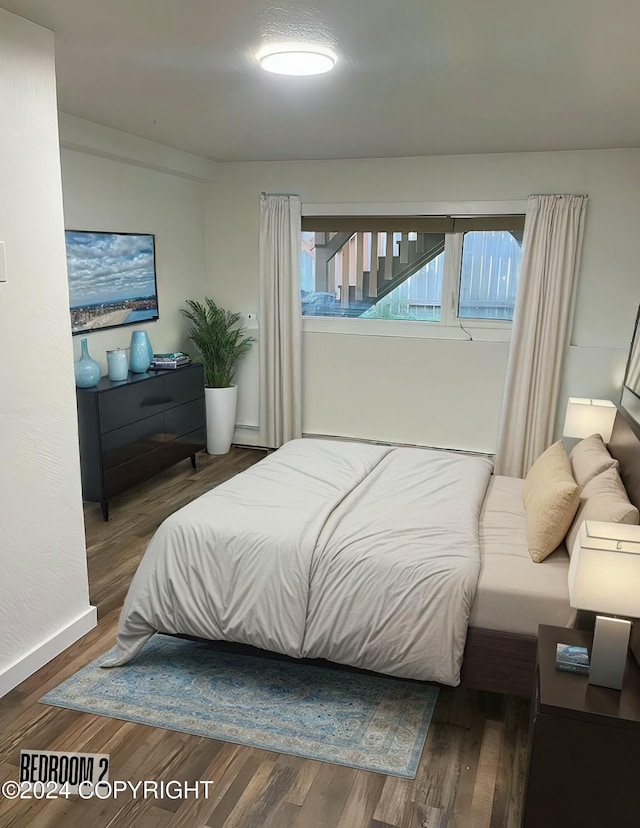 bedroom with hardwood / wood-style flooring