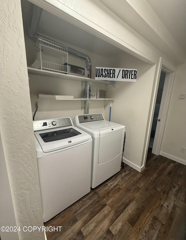 laundry area with washer and clothes dryer and dark hardwood / wood-style floors