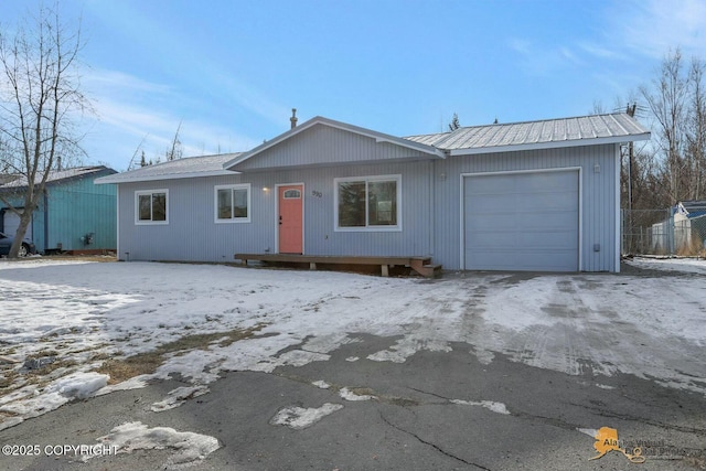 single story home featuring a garage and fence