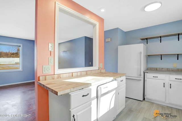 kitchen with white appliances, open shelves, wood counters, white cabinetry, and light wood-type flooring