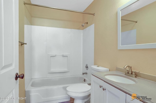 bathroom featuring vanity, toilet, and shower / washtub combination