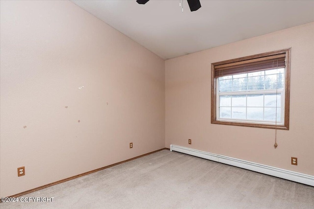 unfurnished room with light carpet, vaulted ceiling, ceiling fan, and a baseboard heating unit