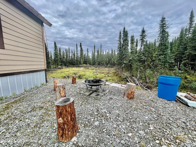 view of yard with a fire pit