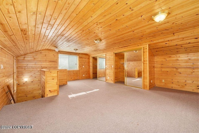 bonus room featuring carpet flooring, lofted ceiling, wood walls, and wooden ceiling