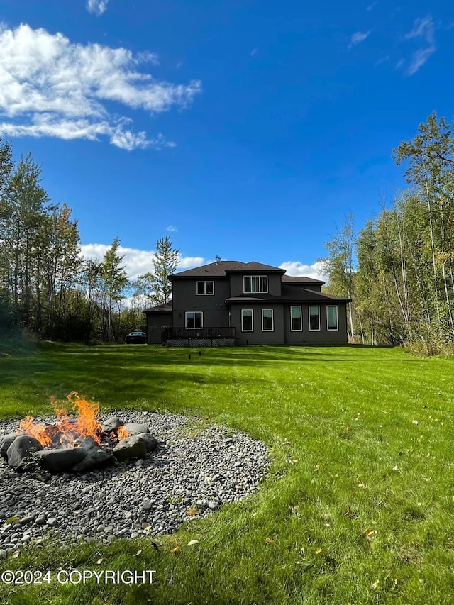 rear view of property featuring a lawn