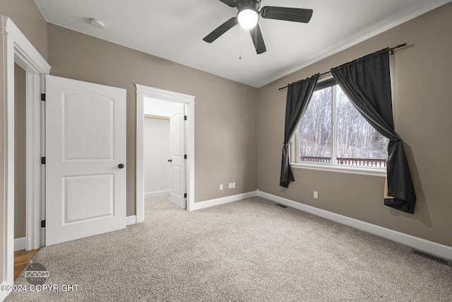 unfurnished bedroom with light colored carpet and ceiling fan