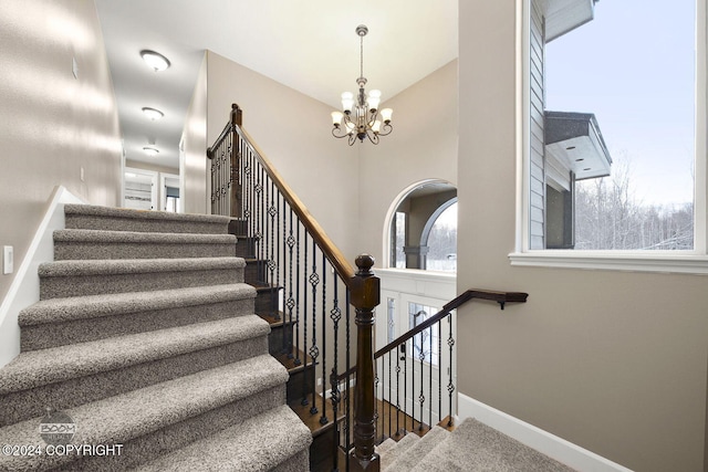 stairway with a chandelier