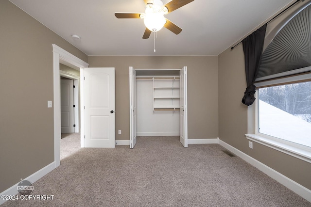 unfurnished bedroom with light carpet, a closet, and ceiling fan