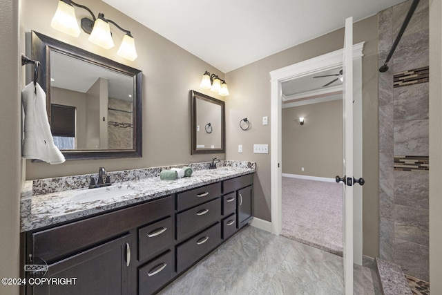 bathroom featuring vanity, ceiling fan, and walk in shower