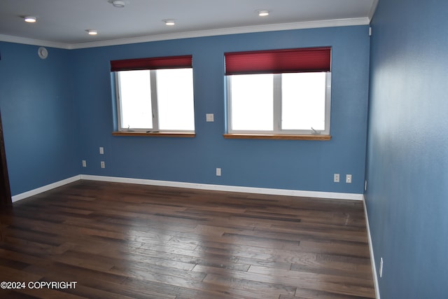 unfurnished room featuring crown molding and dark wood-type flooring