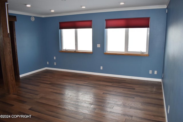 empty room featuring crown molding and dark hardwood / wood-style flooring