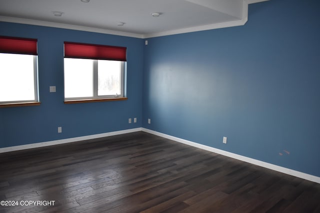 unfurnished room with dark hardwood / wood-style flooring and crown molding