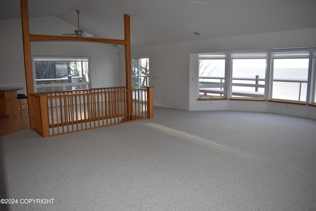 spare room featuring ceiling fan, carpet, and lofted ceiling