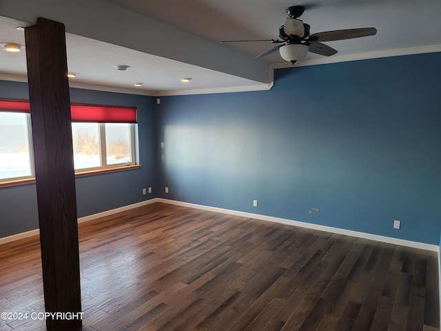 spare room featuring dark hardwood / wood-style flooring, ceiling fan, and crown molding