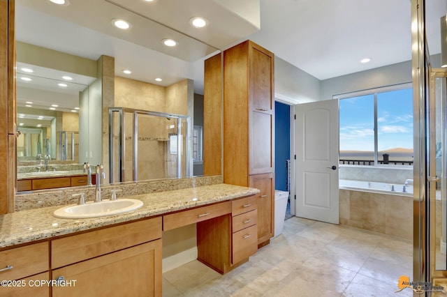 full bathroom featuring a garden tub, a shower stall, vanity, and recessed lighting