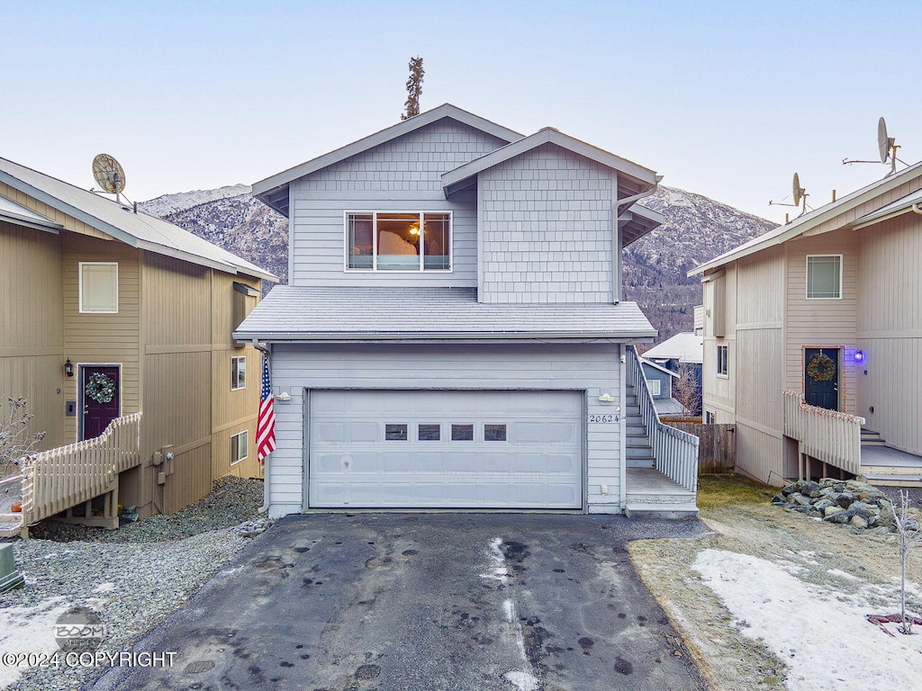 view of front facade featuring a mountain view and a garage