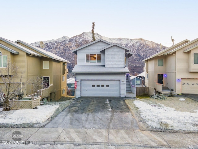 front of property featuring a mountain view and a garage