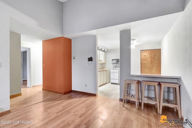 interior space featuring light hardwood / wood-style flooring and baseboard heating