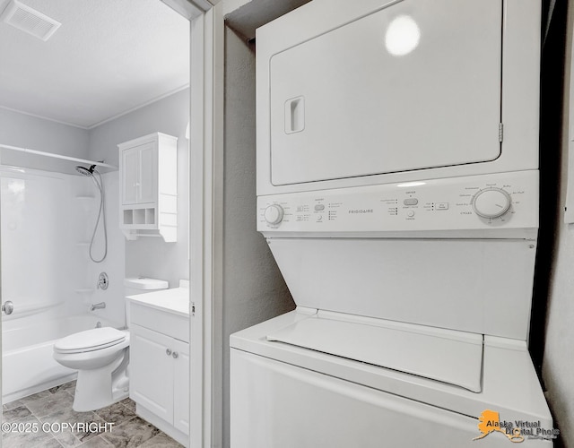 laundry area featuring stacked washing maching and dryer