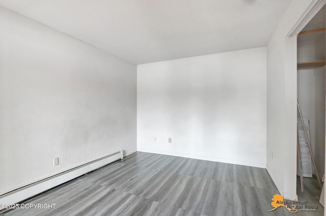 unfurnished room featuring light hardwood / wood-style flooring and a baseboard radiator