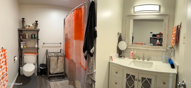 bathroom with a shower with curtain, vanity, toilet, and wood-type flooring