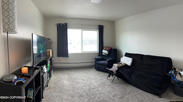 sitting room with baseboard heating, carpet floors, and a textured ceiling