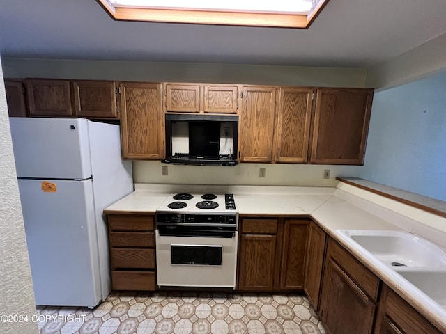 kitchen featuring white appliances and sink