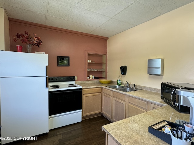 kitchen with light countertops, freestanding refrigerator, dark wood-style floors, electric range, and a sink