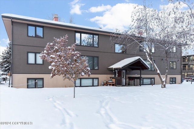 view of snow covered rear of property