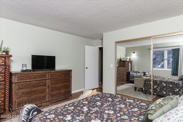 bedroom with a textured ceiling and a closet