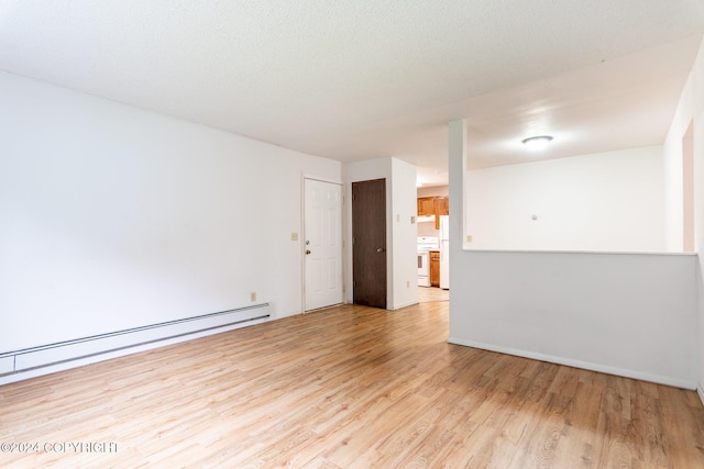 empty room featuring light hardwood / wood-style floors and a baseboard radiator