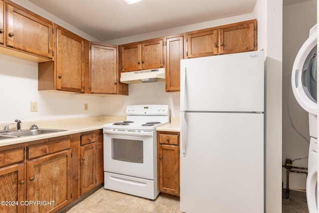 kitchen featuring sink, light tile patterned floors, and white appliances