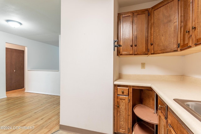 kitchen with light hardwood / wood-style floors and sink