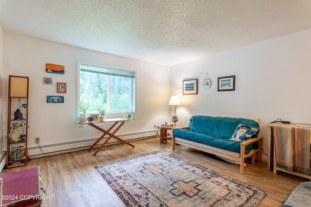 living room featuring hardwood / wood-style floors, a baseboard radiator, and a textured ceiling