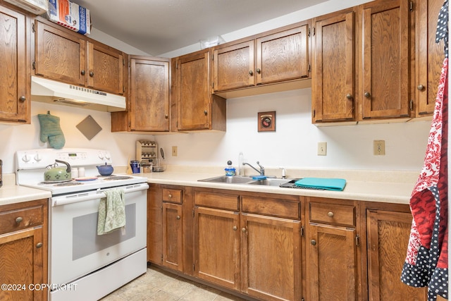 kitchen featuring electric range, light tile patterned floors, and sink