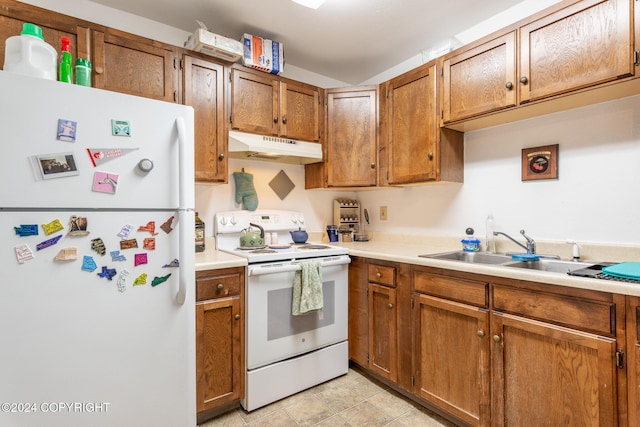 kitchen with sink, light tile patterned flooring, and white appliances