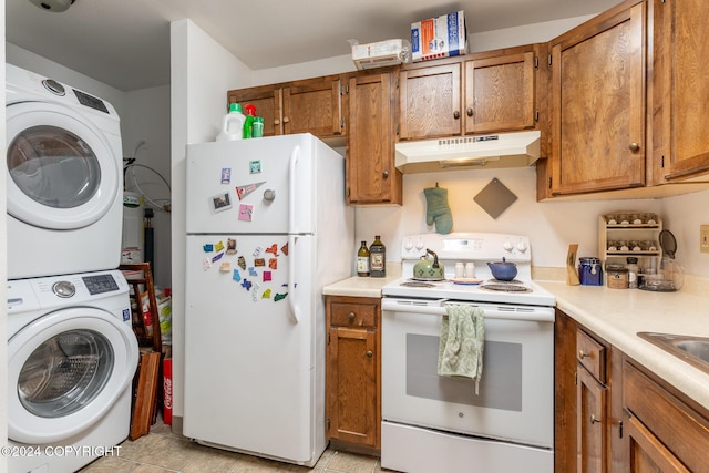 kitchen featuring light tile patterned floors, white appliances, and stacked washing maching and dryer