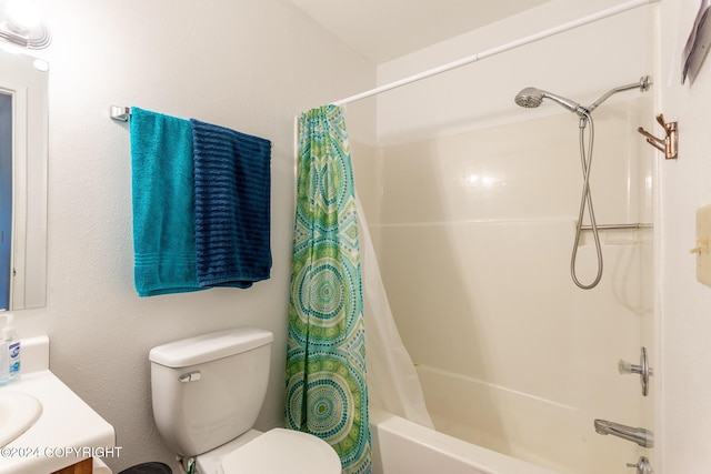 full bathroom featuring shower / bathtub combination with curtain, vanity, and toilet