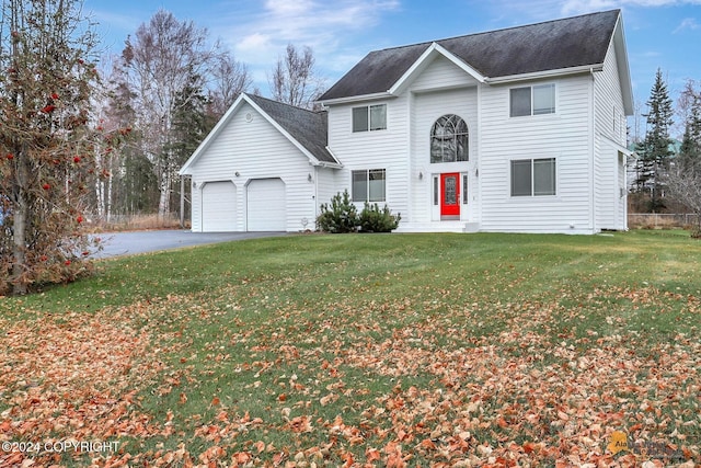 view of front of house with a front lawn and a garage