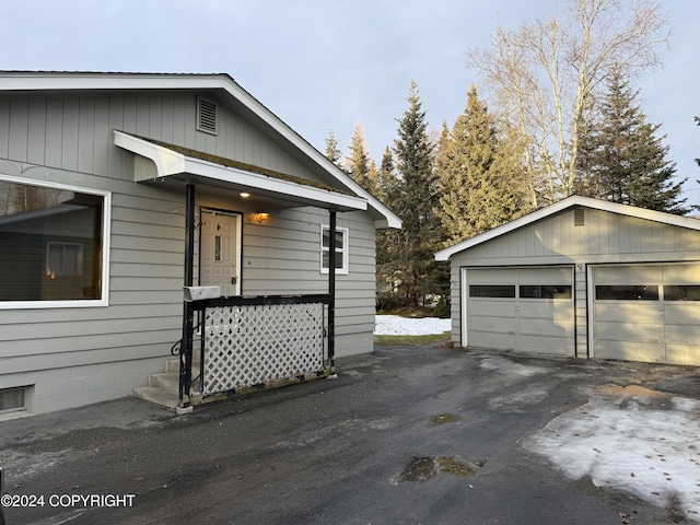 view of side of property with a garage and an outdoor structure