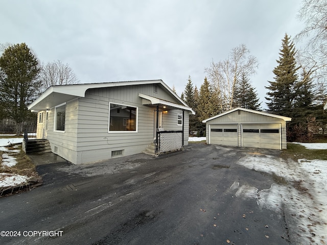 view of front of house featuring a garage and an outdoor structure